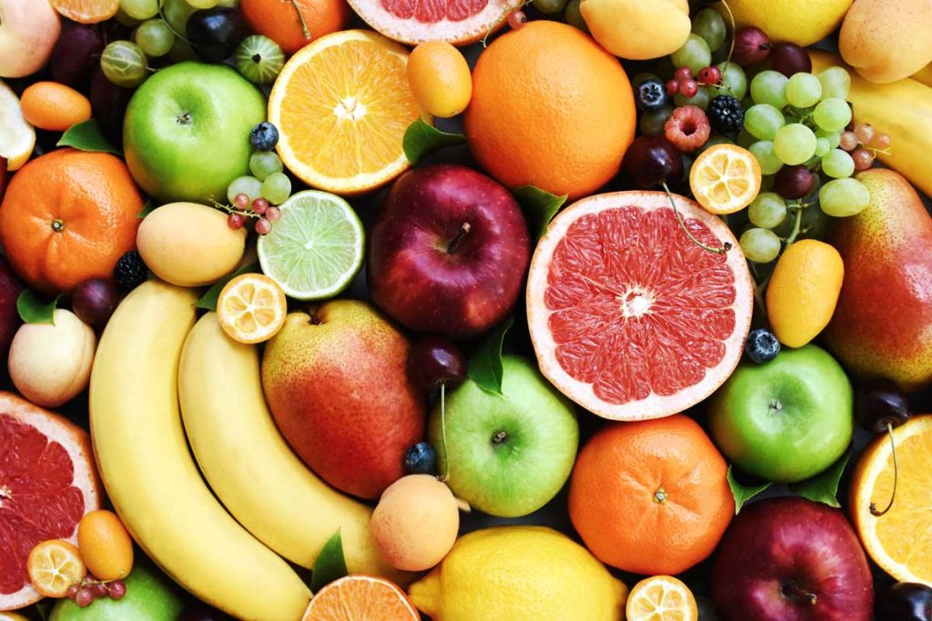 Collection of healthy fruits  including banana, orange, apples and berries, rich in calcium.