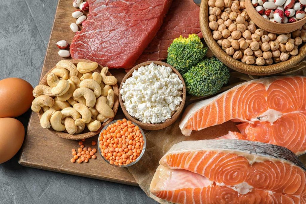 Red meat and salmon surrounded by nuts. Foods rich in calcium.