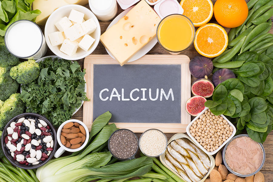 Calcium-rich foods examples including leafy veg, dairy, fish, grains & nuts.